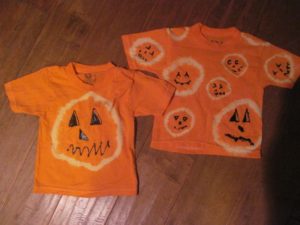 DIY pumpkin t-shirts with faces drawn in
