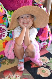 posing with hat pink house