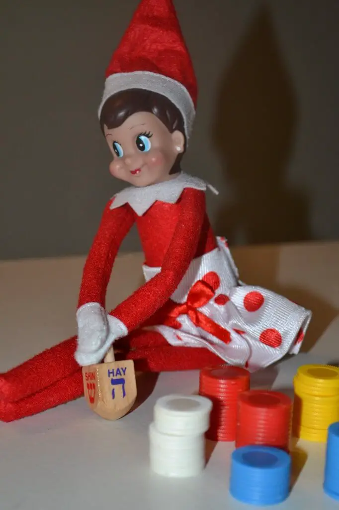 elf playing dreidel elf winning dreidel