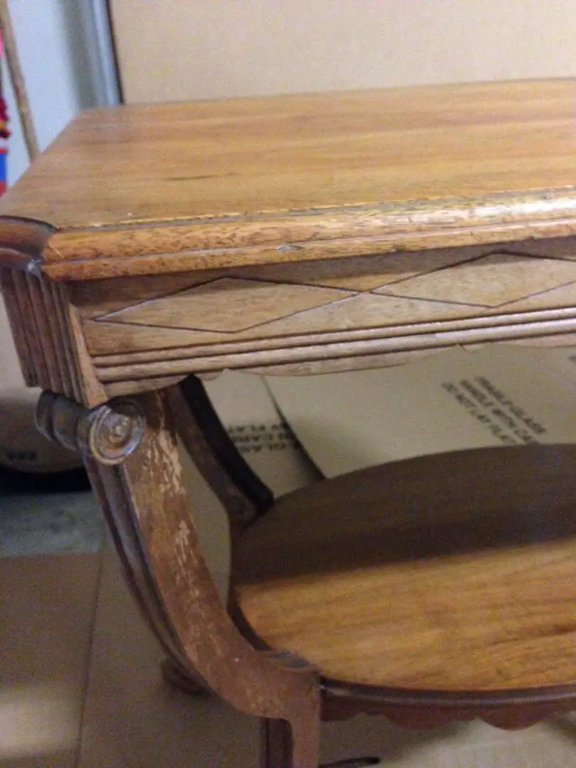 Close up of antique table needing refinishing