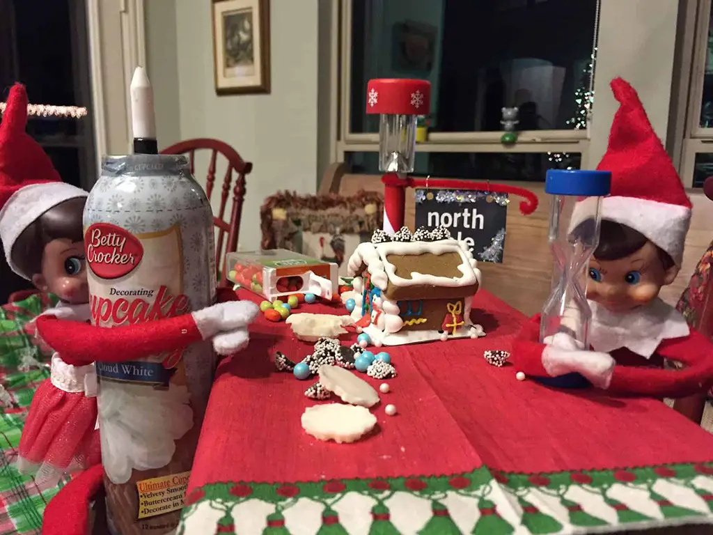 elves decorating gingerbread house