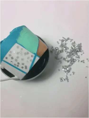 gluing tissue paper on mug