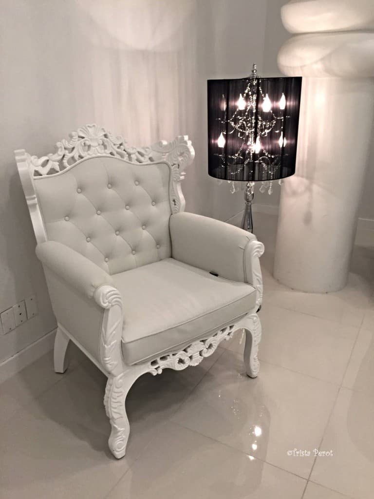 ornate white chair and floor chandelier at modani dallas