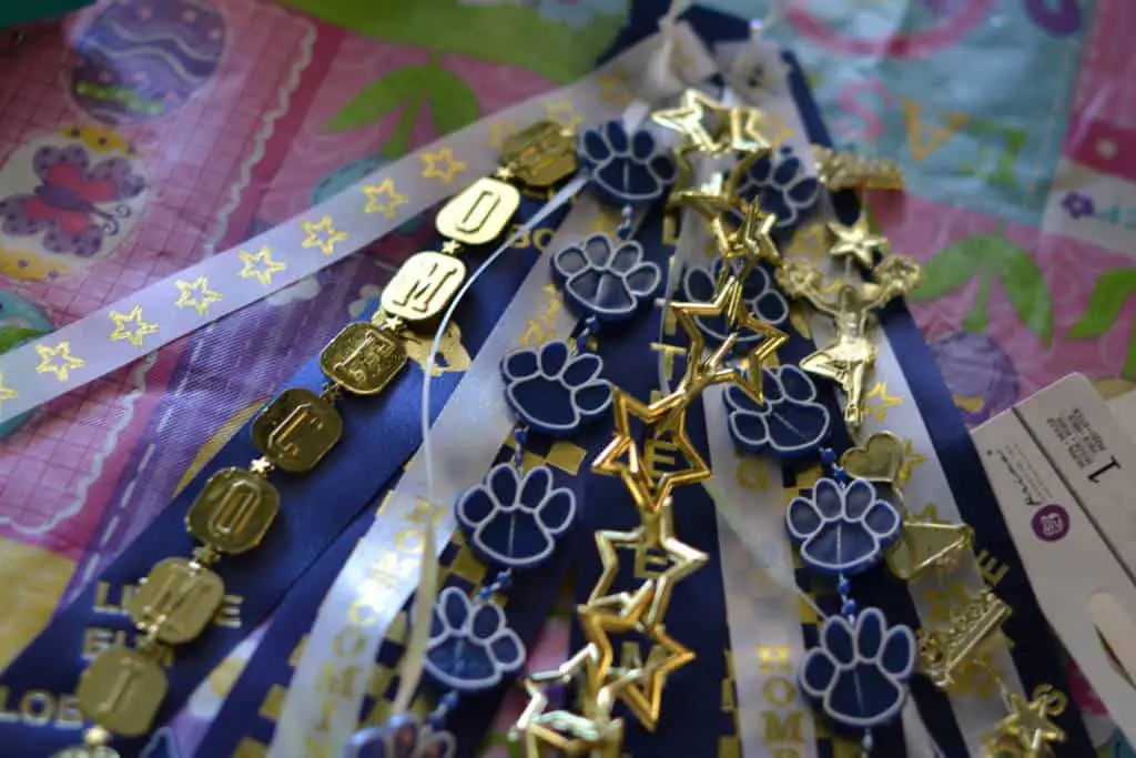 adding plastic garland to homecoming mum