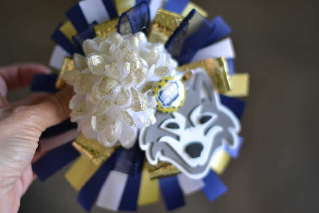 adding mum to ribbons, making a homecoming mum