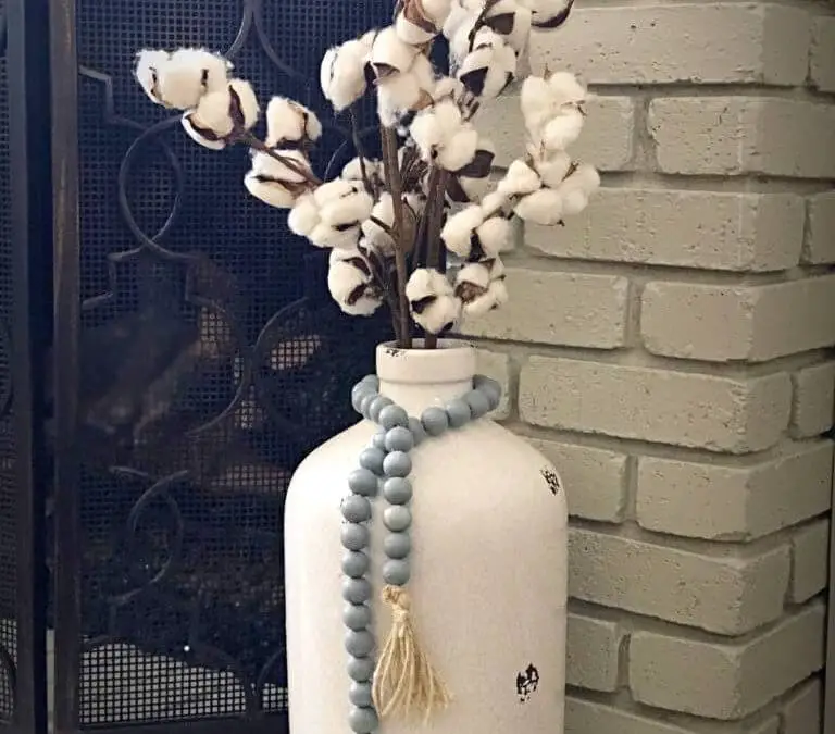 Wooden bead garland around a vase