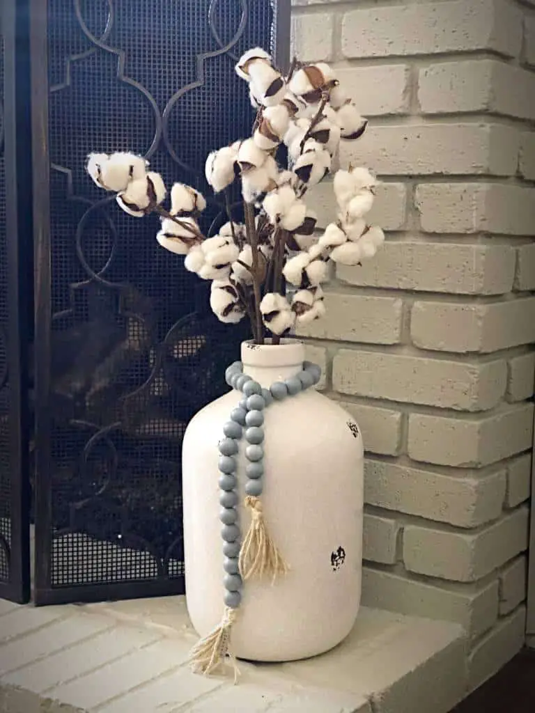 Wooden bead garland around a vase